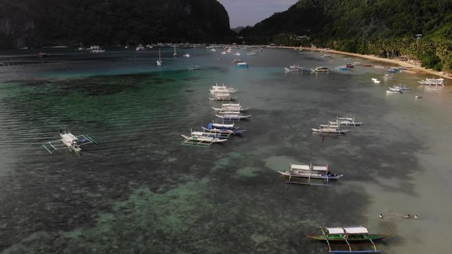 Forward overflight of small fishing boats at Corong Corong beach in Palawan, Philippines