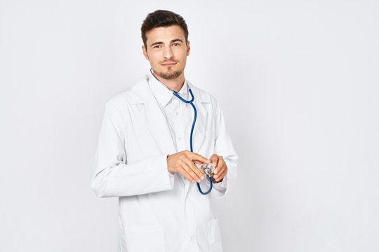 portrait of a young doctor with stethoscope isolated on white
