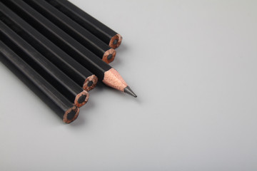 Black pencil on gray background