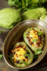 chayote stuffed baked stuffed with minced meat, corn and pieces of the chayot with cheese sauce