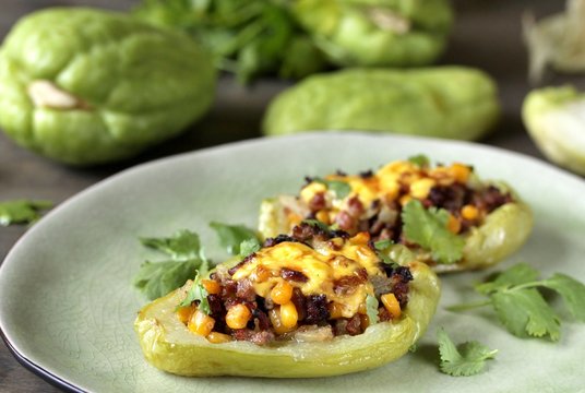 chayote stuffed baked stuffed with minced meat, corn and pieces of the chayot with cheese sauce