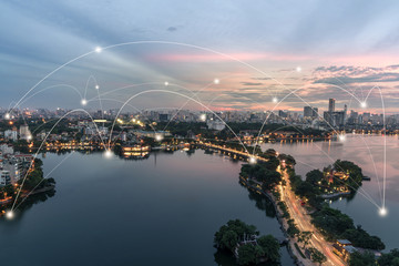 Fototapeta premium Smart city and wireless communication network concept. Digital network connection lines of Hanoi city at West Lake or Ho Tay