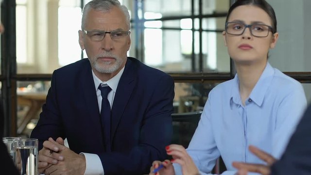 Businessman doubting honesty and experience of partners at meeting, mistrust