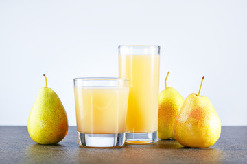 Pear Juice with fresh fruits on kitchen table with place for text.