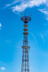 Tower of communication against the blue sky.