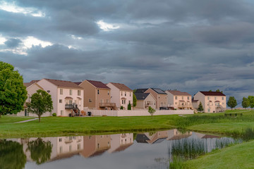 Beautiful homes with a scenic view of a shiny pond and expansive grassy field