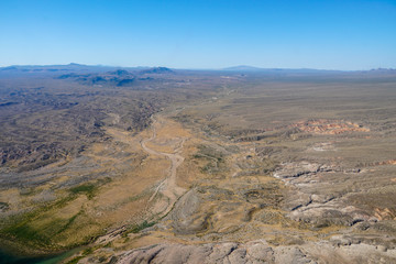 Fototapeta na wymiar Aerial view of desert next the Lake Mead in Mohave County, Arizona, United States. Arid endless desert during hot summer season