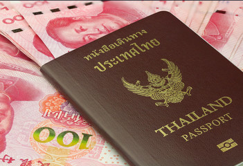 Closed up of Thailand passport with Chinese Yuan banknote background . Concept ,Thai people travel to Chinese..