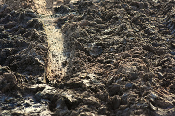 Tire trace over the dirt ground.