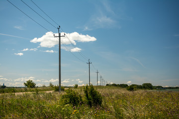 Fototapeta na wymiar power poles on the road sky