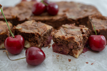 Chocolate brownie pieces decorated with cherry