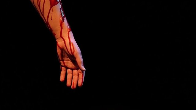Blood dripping of an arm in slow motion