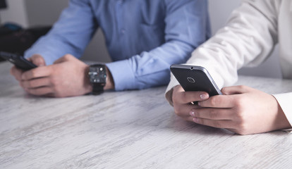 Two business people holding smartphone
