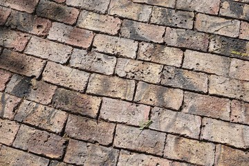 Ancient brick walkway with rough irregular shaped bricks