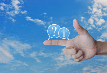 Question mark and information chat icon on finger over blue sky with white clouds, Business customer support concept