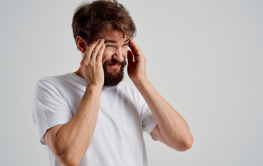 young man with headache isolated on white