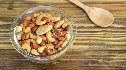 Bake mixed nuts on a wooden table.
