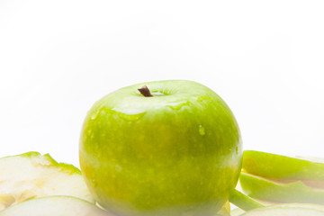 Close up of the green apple with drops and slices