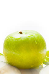 Close up of the green apple with drops and slices