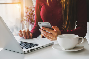  Woman using smart phone for mobile payments online shopping,omni channel,sitting on table,virtual...