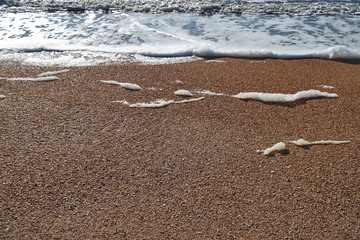 Fototapeta na wymiar Image of sea foam on a sandy beach.