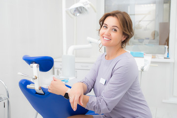 Woman dentist smiling in office