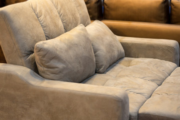 The pillow is leaning on the leather sofa as a beautiful backdrop.