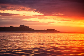Fototapeta na wymiar sunset over sea with castle silhouette 