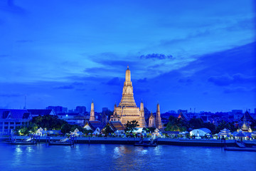 Fototapeta premium Bangkok city ,Thailand - April 15, 2019:Night time view of Wat Arun (Temple) across Chao Phraya River in Bangkok, Thailand 