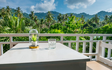 Table on the terrace for dining and enjoy the beautiful natural landscape of forest and mountains in the morning atmosphere at Phangan island Thailand - obrazy, fototapety, plakaty