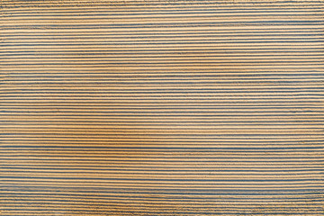 Top aerial view of on smooth furrows lines freshly planted agriculture plants in the soil.