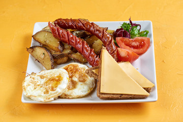 hearty breakfast of eggs, potatoes and sausage