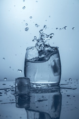 Splash of water splashing falling piece of ice