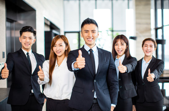 Asian Business Team Standing And Showing Thumbs Up