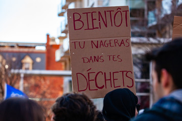 French placard at ecological protest. A french poster, saying soon you will swim in your rubbish, is viewed closeup as environmental activists march in the city center