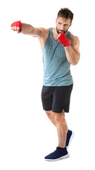 Strong male boxer on white background