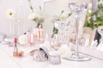Makeup cosmetics on white dressing table