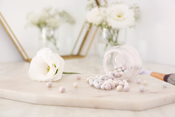 Obraz na płótnie Canvas Jar with powder pearls on board