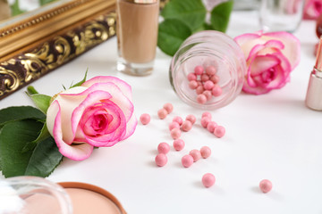 Rose flowers with makeup cosmetics on dressing table