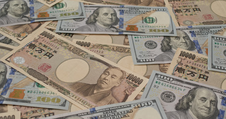 Stack of Japanese yen and USD