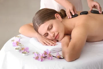 Keuken achterwand Spa Beautiful young woman undergoing treatment with hot stones in spa salon  © Pixel-Shot