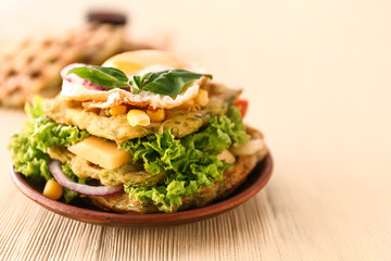 Plate with tasty squash waffles and fried egg on wooden table