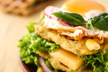 Tasty squash waffles with fried egg on table, closeup