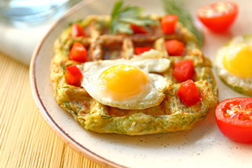 Tasty squash waffles and fried egg on plate, closeup