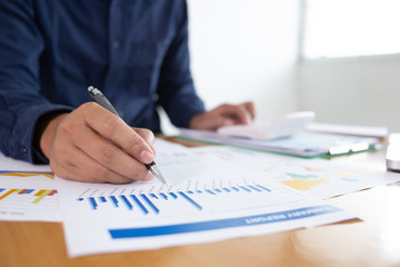 Image of two young businessmen using touchpad at meeting