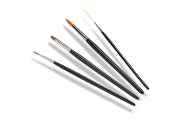 Set of cosmetic brushes, different forms. Isolated on white background. Top view. Cosmetics and beauty concept. Copy space