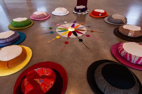 Sacred items form circle in prayer room. A closeup view on the 12 colors of the Native American-Indian symbolic color wheel, laid around a compass inside a worship room, believed to bring good health.