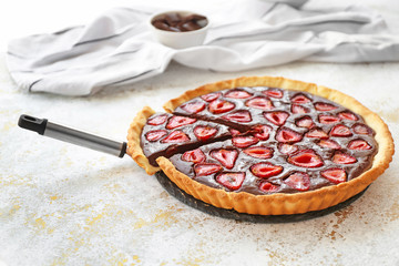 Tasty chocolate strawberry cake on light table