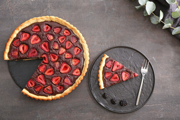 Tasty chocolate strawberry cake on grunge background