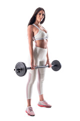 Athletic young fitness model gym woman posing while holding barbell looking at camera. Full body isolated on white background. 